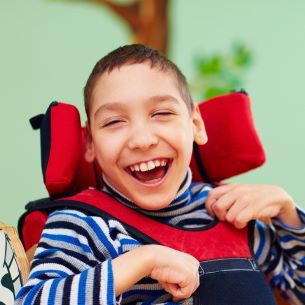 Child with developmental disability smiles.