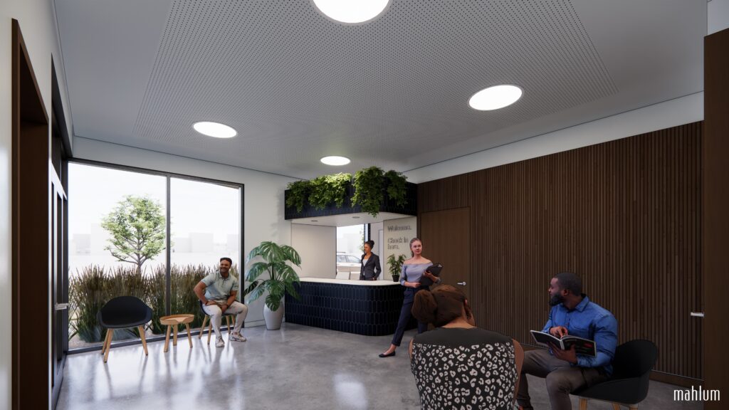 People sitting in a wood-paneled room with a reception desk and plants.