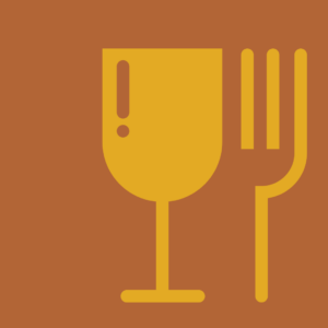 A yellow goblet and fork on a brown background