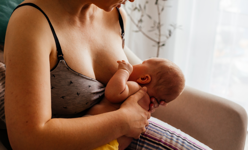 A person breastfeeding a baby.