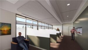 A room painted in shades of green with large frosted windows features six reclining chairs, separated by privacy dividers and a snack area.