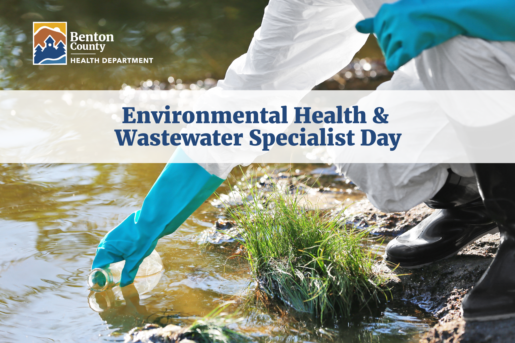 A person wearing a white protective suit, black rubber boots, and turquoise gloves dips a glass beaker into a natural water source to take a sample for testing. Text reads, "Environmental Health & Wastewater Specialist Day."