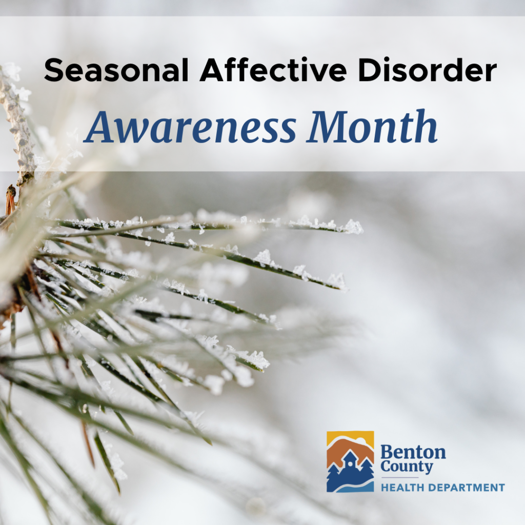 A wintery background with snow on a pine tree promoting seasonal affective disorder awareness month.
