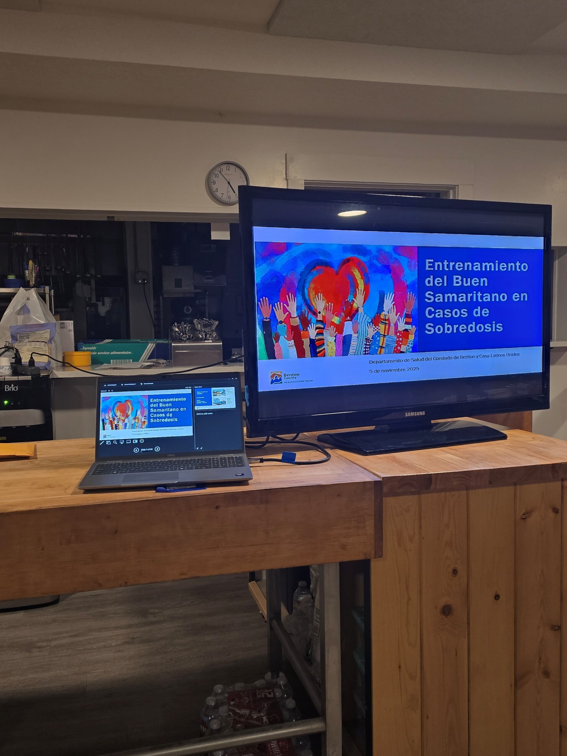A computer on a desk shows a PowerPoint presentation for Good Samaritan Overdose Training.