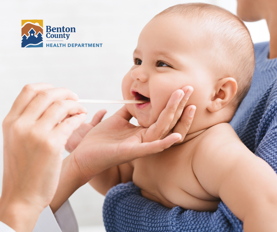 A baby receives a medical examination.