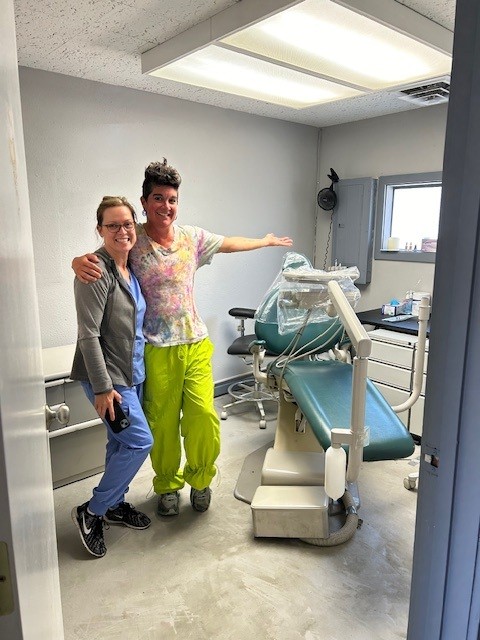 Staff and partner pose with dental equipment for unhoused community members dental clinic.