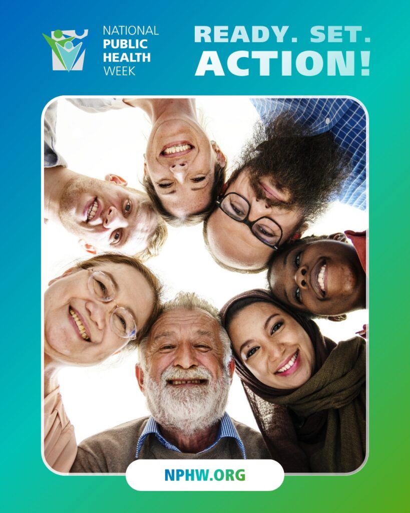 Group of diverse people standing in a circle looking down, symbolizing unity for National Public Health Week.
